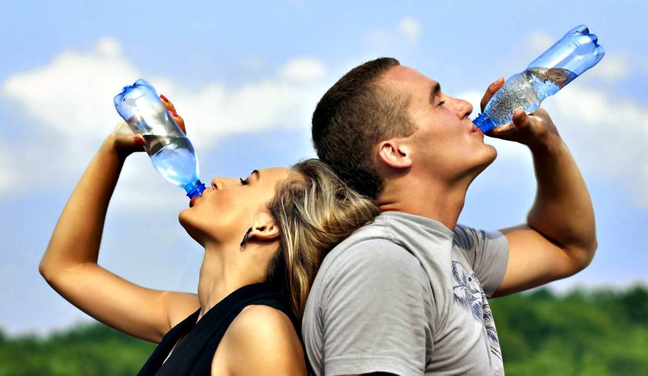 A man and woman drinking water